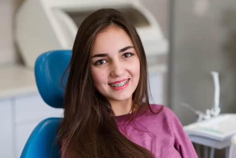 A young woman with long brown hair and braces Georgetown TX - Overbite vs Underbite in Georgetown, TX.