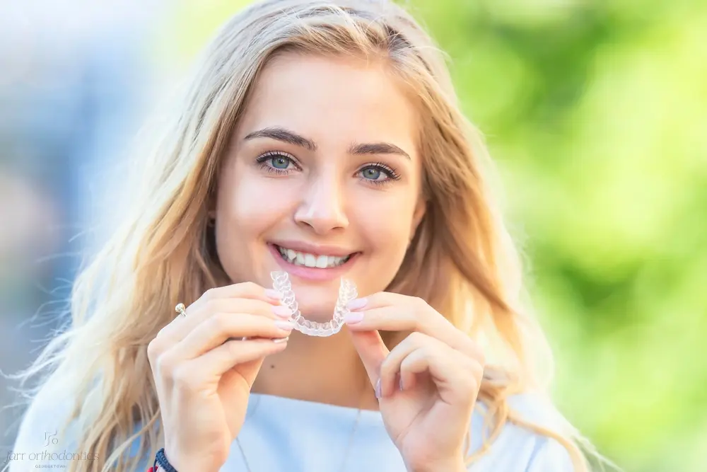 invisalign clear aligners orthodontics concept young attractive woman - Alternatives to Braces in Georgetown, TX 