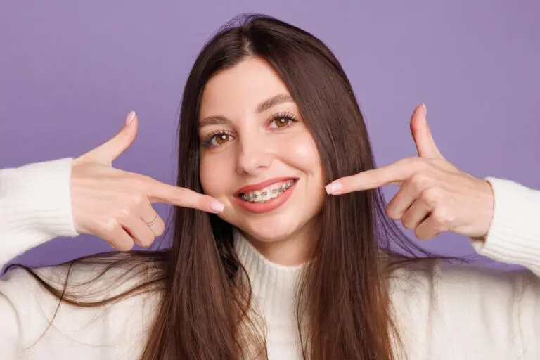portrait girl braces woman happy metal braces shows sign - Alternatives to Braces in Georgetown, TX